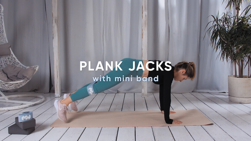 Plank jacks with mini band