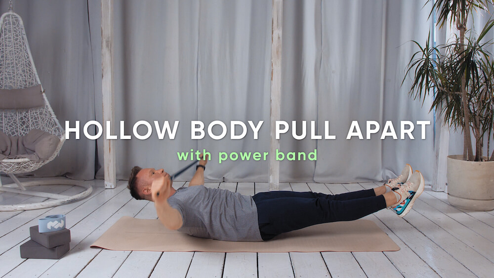 Zdjęcie ćwiczenia Hollow body pull apart with power band